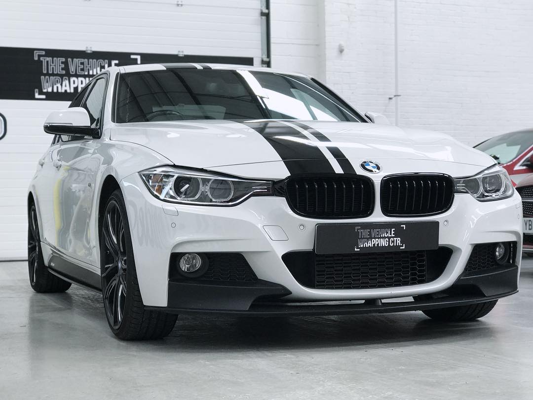 A beautiful BMW with a racing stripe, having undergone a new wrap at The Vehicle Wrapping Centre.