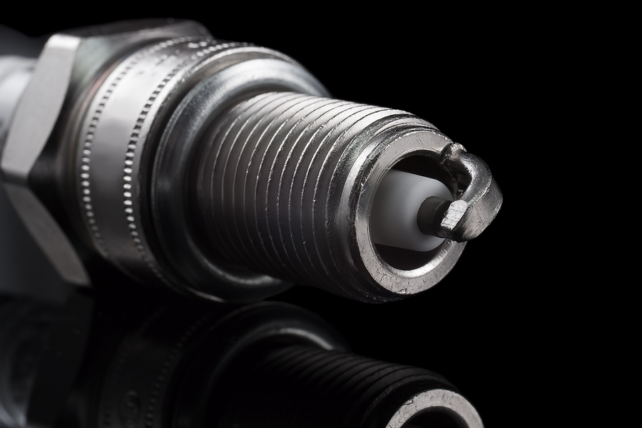 One spark plug on a black background. The small depth of field.