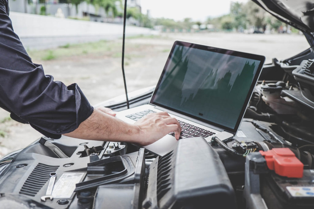 A car engine undergoing a digital diagnostics test.