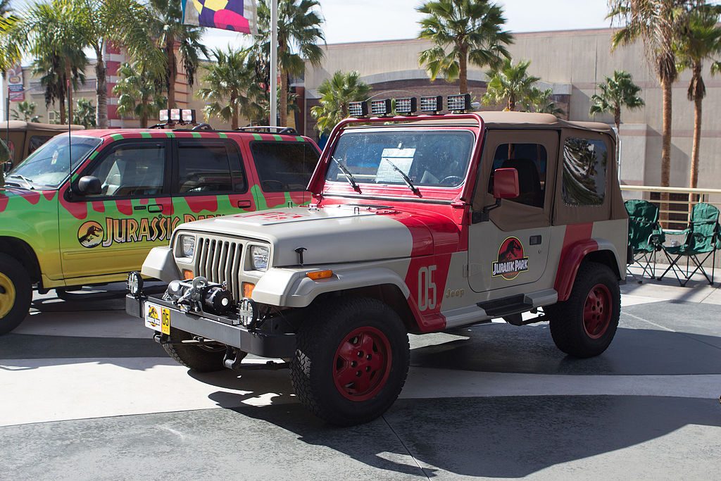 A picture of a Jurassic Park Jeep in a car park. 