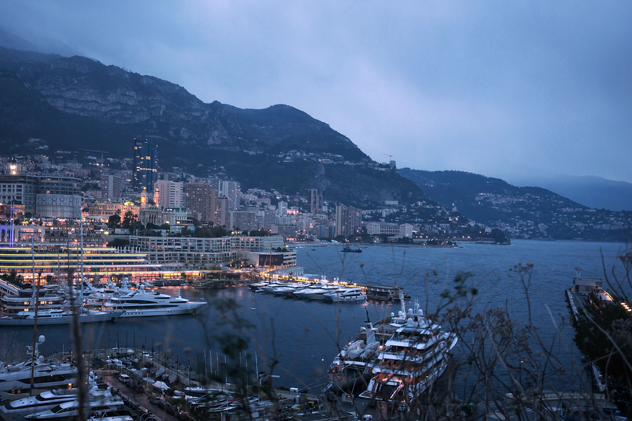 Night cityscape of Monte Carlo by marina, riviera of Monaco. Marine Monte Carlo with yachts and boat. Evening view of the city.