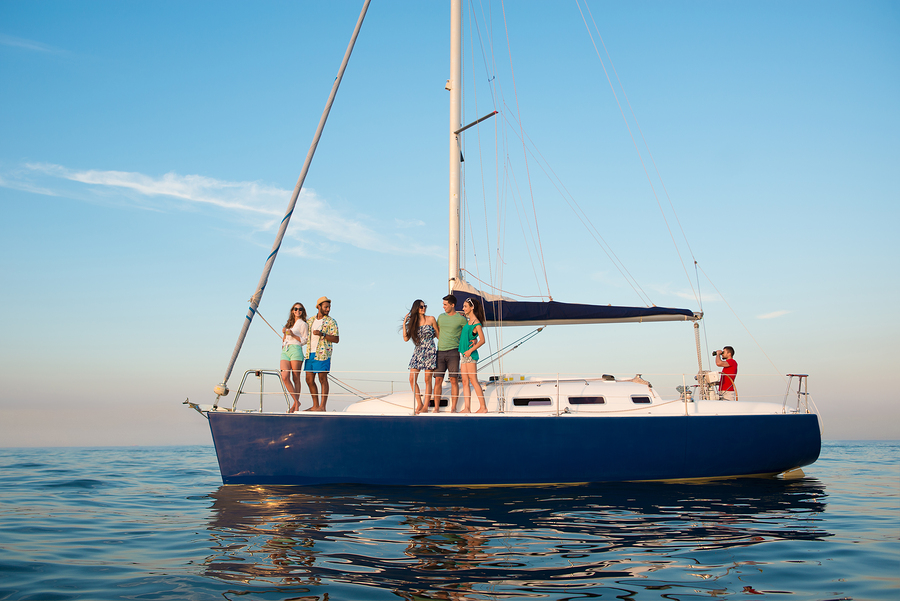 Young people is resting on a sailing yacht at sea. Weekend on a yacht. 