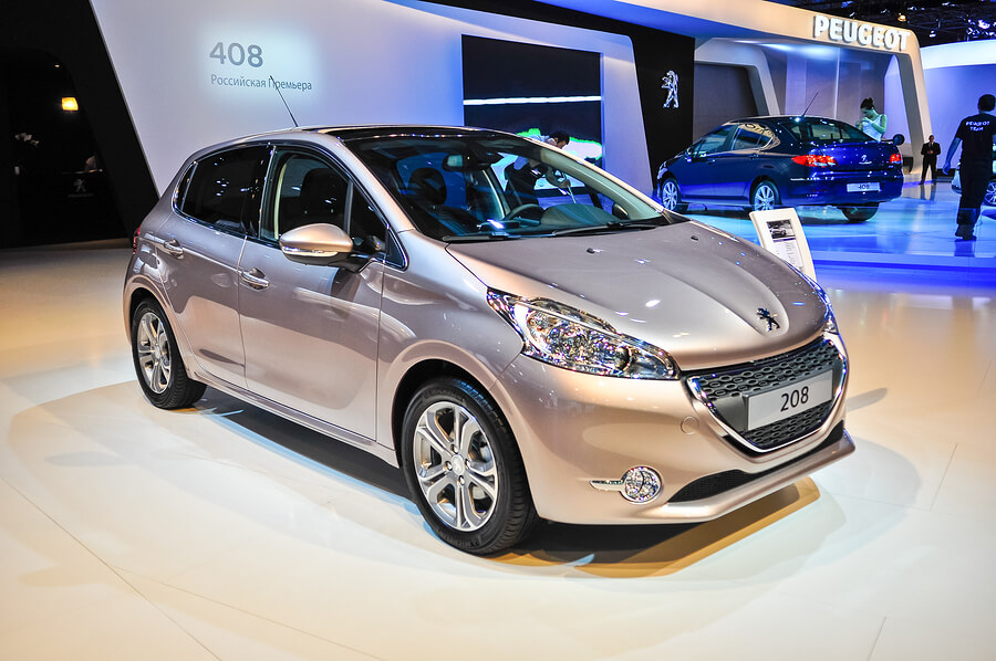 A Peugot 208 on display in a showroom.