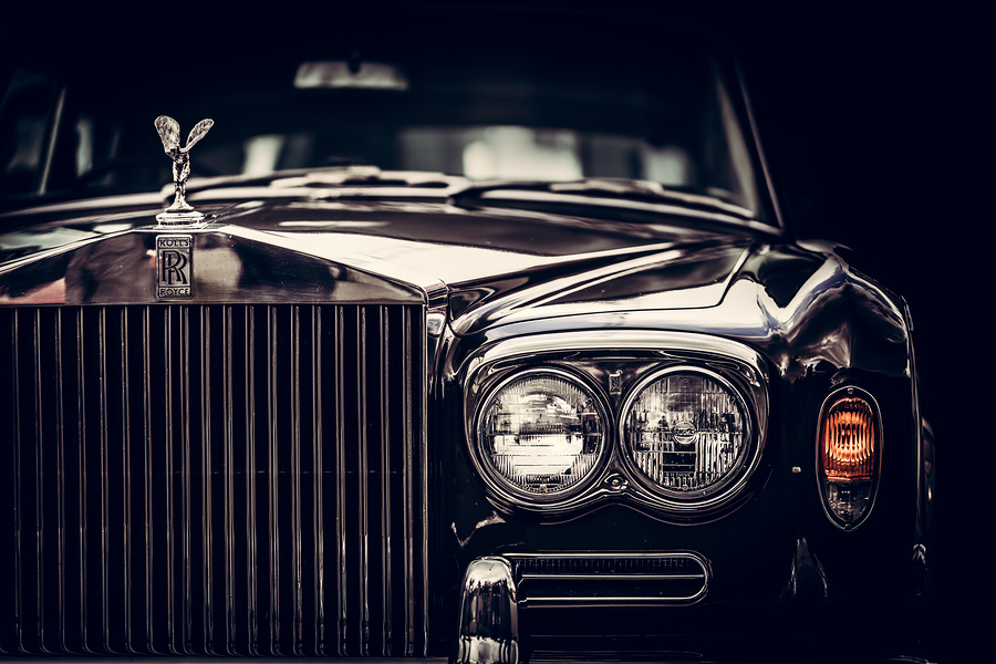 Rolls-Royce - classic British car on black background, close-up. Rolls-Royce remains a symbol of a luxurious car.