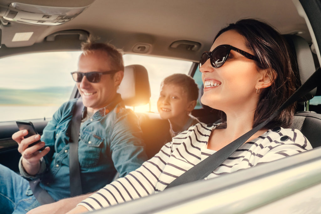 Family driving in sunlight